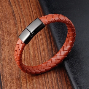 Detail of orange brown braided leather bracelet with matte black magnetic clasp