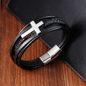 Close-up of black braided leather bracelet with a polished silver stainless steel cross charm