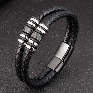 Detail of double-layer black braided leather bracelet with stainless steel metal rings