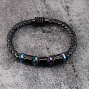 Detail of woven black leather bracelet with rainbow rings and magnetic clasp closure