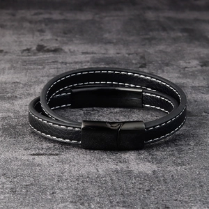Close-up of black double-wrap leather bracelet with white stitching and magnetic clasp