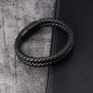 Close-up of black double-strand braided leather bracelet with matte metal magnetic clasp
