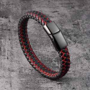 Close-up of men's braided black leather bracelet with red stitching and magnetic clasp