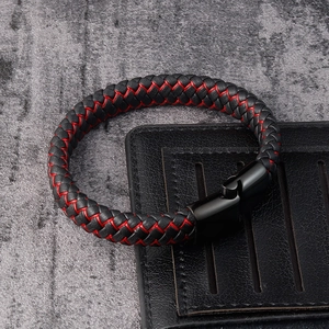 Detail of men's braided leather bracelet featuring red stitching and black metal clasp