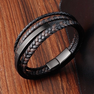 Men's multilayer braided leather bracelet with black magnetic clasp on wood background