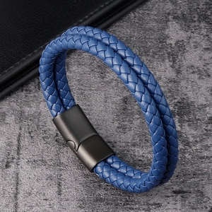 Detail view of blue braided leather bracelet with black matte magnetic metal clasp
