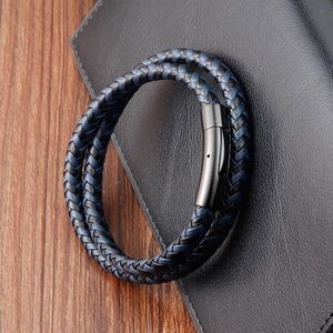 Detail of navy blue and black woven leather double-layer bracelet with magnetic metal clasp