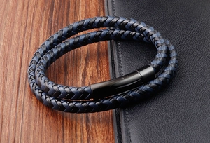 Detail of double-layer braided leather bracelet with black magnetic clasp for men
