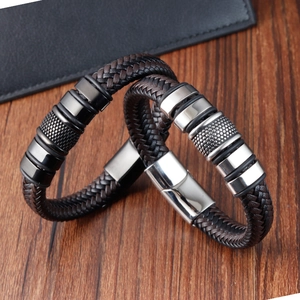 Men's handmade woven leather bracelets with magnetic stainless steel clasps on wood