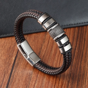 Vintage braided leather bracelet for men with stainless steel magnetic clasp on wood table