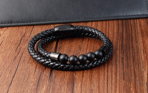 Close-up of men's double-layer black braided leather bracelet with matte stone beads