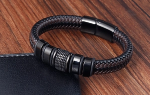 Close-up of woven black and brown leather bracelet with magnetic stainless steel clasp