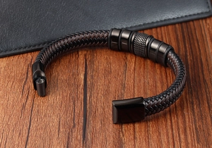 Detail of magnetic clasp closure on handmade dual-tone woven leather bracelet for men