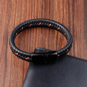 Men's black braided leather bracelet with titanium steel magnetic clasp on wood