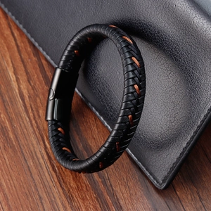 Detail of black braided leather men's bracelet with brown stitching and magnetic clasp
