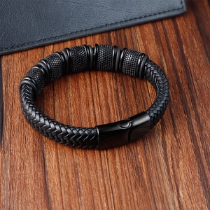 Close-up of black braided leather bracelet with matte black metallic beads and clasp