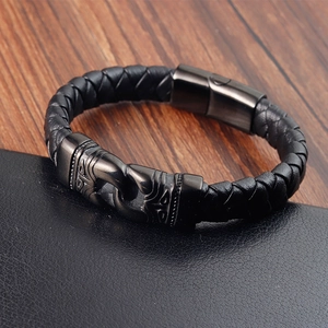 Men's black braided leather bracelet featuring engraved gunmetal magnetic clasp and totem pattern