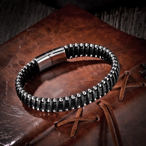 Close-up of black leather multi-layer bracelet with silver beads and polished metal clasp