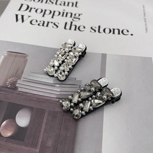 Luxury rhinestone duckbill hair clips with crystals and pearls on minimalist magazine