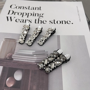 Luxury 5-piece hair clip set featuring sparkling rhinestones and pearls on black bases