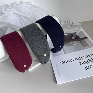 Detailed side view of three fabric headbands in burgundy, dark grey and navy blue colors