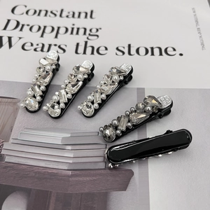 Five-piece luxury hair clip set with sparkling rhinestones and white pearls on black base