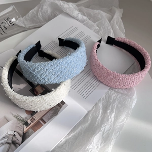 Three sequined tweed wide headbands in cream, blue, and pink for a high-volume hair look