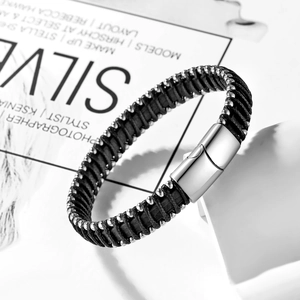 Detail of multi-strand black woven leather bracelet with silver beads and magnetic clasp