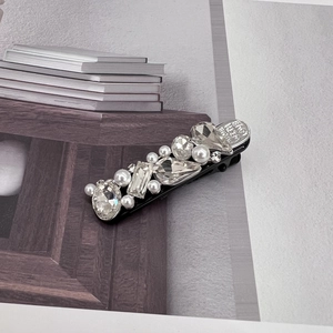 Detail shot of duckbill clip with rhinestones and Made With Love engraving