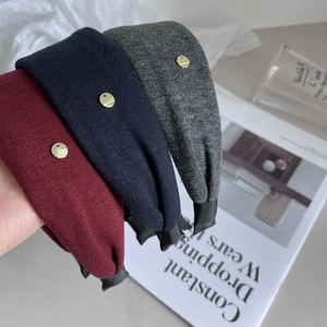 Three minimalist knitted fabric wide headbands in burgundy, navy blue, and deep grey colors