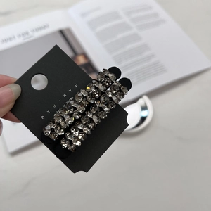 Vue détaillée de deux élastiques à cheveux noirs de luxe ornés de strass gris étincelants