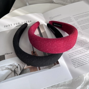 Handmade wool texture padded headbands in black and rose red colors on a magazine