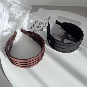 Elegant wide fabric headbands in black and brown with horizontal pleats for women