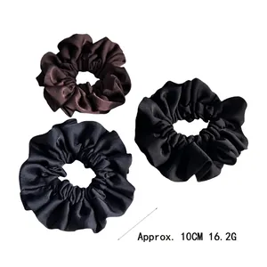 Three-pack of glossy satin scrunchies in coffee, black, and blue, 10cm diameter