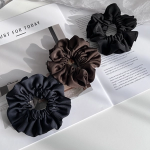 Three-piece set of satin hair scrunchies in black and brown, elegant silk-like hair ties