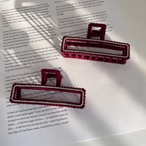 Set of 2 burgundy velvet hair claws with rhinestones on vintage book pages backdrop
