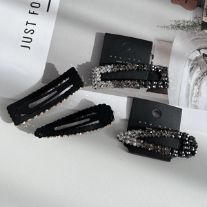 Sparkling rhinestone hair clip set with four pieces on a minimalist white background