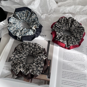 Three-piece set of floral fabric scrunchies in navy, wine red, and brown vintage patterns