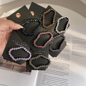 Set of sparkling crystal hair ties in seven colors on branded cards with Korean style
