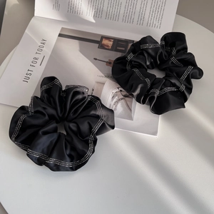 Elegant black satin scrunchies set with sparkling rhinestone details for women's hair styling