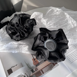 Elegant black satin scrunchies with sparkling silver rhinestones in a stylish layout
