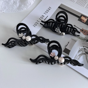 Three elegant camellia pearl hair claws in black, white and pink for hair styling
