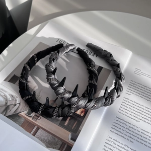 Detail showing twist silk fabric headbands with sparkling rhinestones and gothic rivet studs