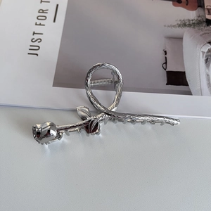 Detailed view of silver rose metal hair claw clip with intricate petal textures