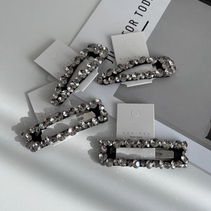Sparkling rhinestone hair clip set with four rectangular and oval crystals on card