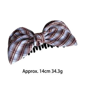 Plaid pattern bow banana hair clip in brown and light blue checkered fabric, 14cm long