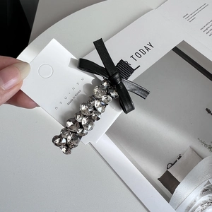 Elegant black bow hair clip with sparkling rhinestones and silver alloy base finish