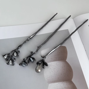 Detail of gunmetal flower hair pins with grey pearls in a modern Chinese style set