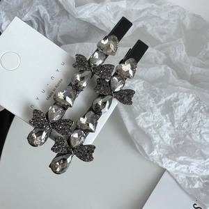 Detail of luxury rhinestone hair clips with heart and butterfly crystals in black setting