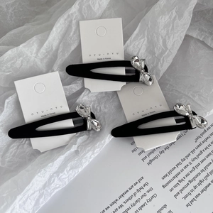Three-piece set of black flocked hair clips with rhinestone bowknot on display card